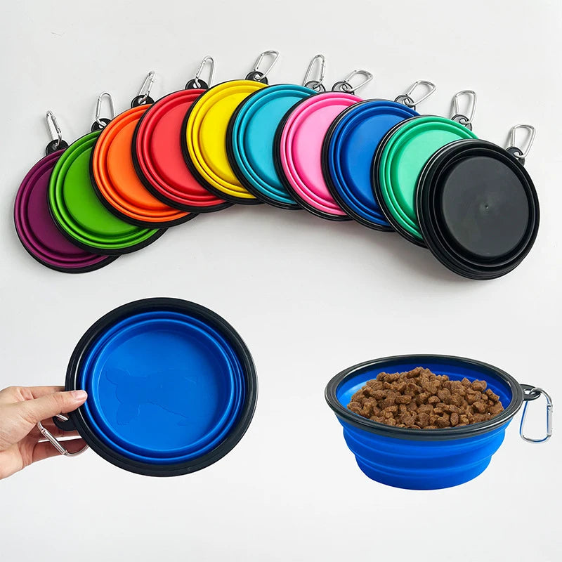 Set of colorful collapsible pet bowls with a hand holding one and another filled with food.
